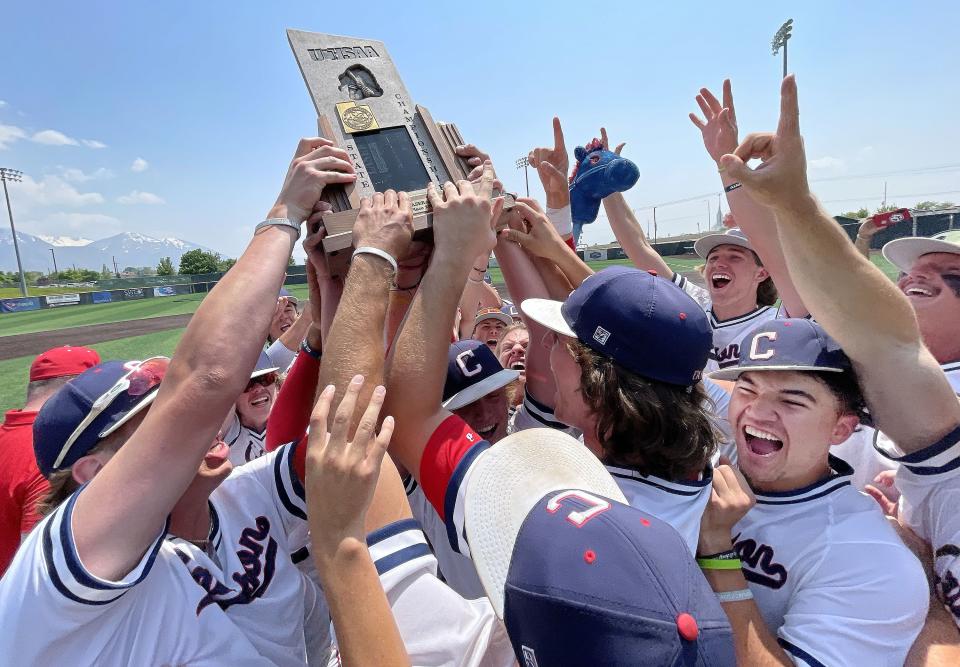 Crimson Cliffs celebrates their win over Snow Canyon by raising the Deseret News trophy in the 4A state championship at UVU in Orem on Saturday, May 20, 2023. | Jeffrey D. Allred, Deseret News