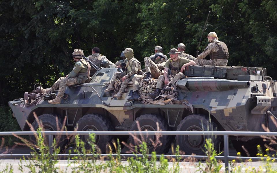 Ukrainian soldiers travel down a road near Druzhkivka, Ukraine. In recent weeks, Russia has concentrated its firepower on Ukraine's Donbas region - Scott Olson/Getty Images