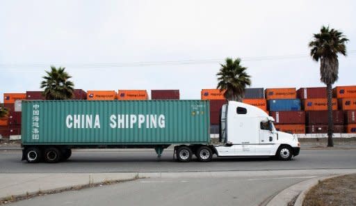 A truck pulls a trailer loaded with a China Shipping container at the Port of Oakland in California. China's trade surplus narrowed to $25.1 billion last month from $31.7 billion in June. That marked the second straight month that both exports and imports weakened