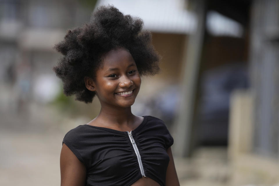 A girl poses for a photo on a "humanitarian space," a neighborhood once plagued by grisly killings that the community, backed by international observers, carved out as a non-violent zone, in Buenaventura, Colombia, Thursday, Aug. 17, 2023. Buenaventura’s “humanitarian space” is a former red zone transformed with the help of human rights groups as a place for community, safety and activism. (AP Photo/Fernando Vergara)