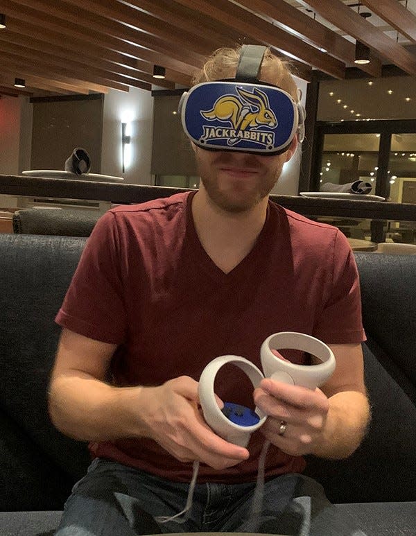 A Jackrabbit fan at South Dakota State University practices using a new VR headset to be implemented when SDSU becomes a "metaversity."