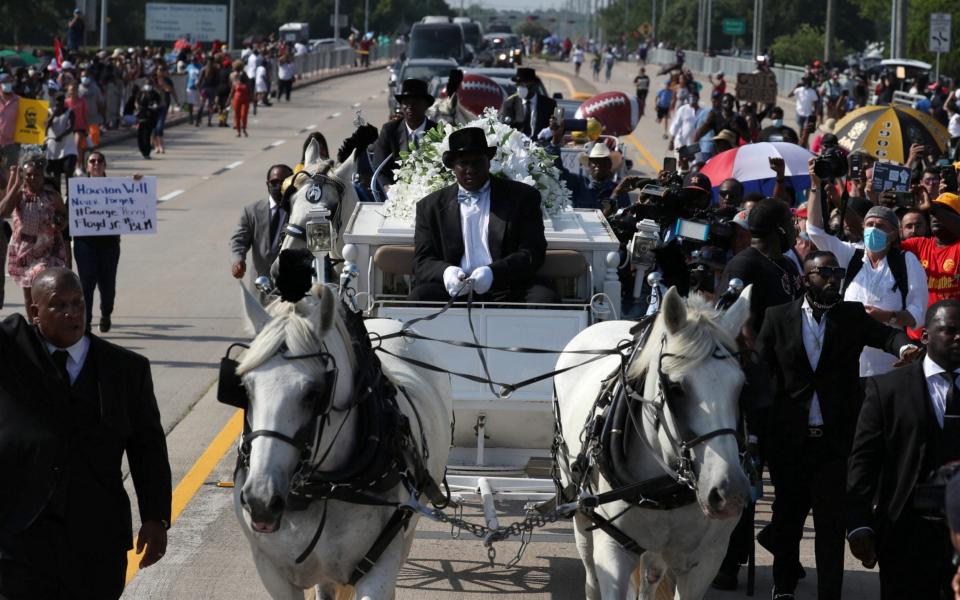 The coffin of George Floyd is seen in a horse-drawn carriage before it arrives at the Houston Memorial Gardens cemetery in Pearland, Texas - Reuters