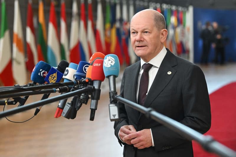 German Chancellor Olaf Scholz speaks to the media upon his arrival to attend the Special European Council meeting in Brussels. -/European Council/dpa