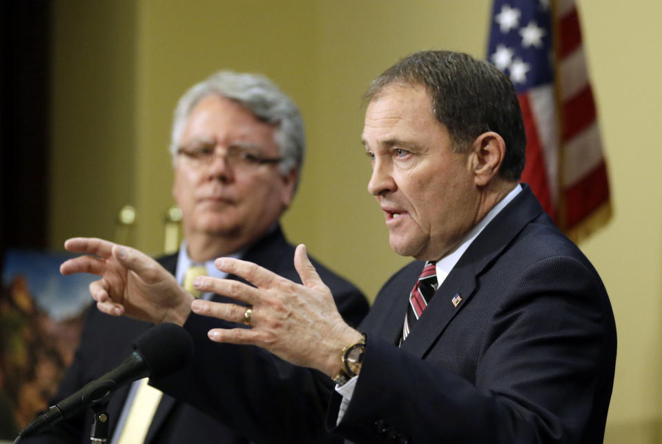 Utah Gov. Gary Herbert makes remarks during a news conference where he discussed Medicaid expansion, while Dr. W. David Patton, of the Utah Department of Health, looks on Thursday, Feb. 27, 2014, in Salt Lake City. Herbert announced he wants to reject a full Medicaid expansion, and instead seek federal dollars to cover the poor. Herbert made the announcement Thursday afternoon, saying the state has an obligation to cover the poor by plugging a hole in the safety net. AP Photo/Rick Bowmer)