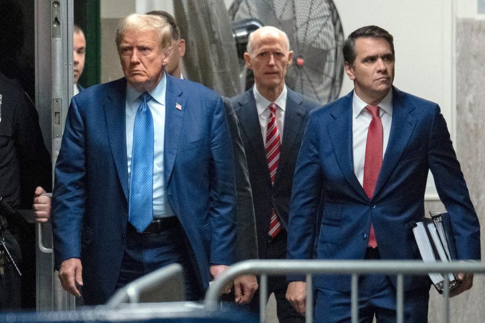 Donald Trump (left), Rick Scott (centre) and attorney Todd Blanche (right) walk into the Manhattan Criminal Court on 9 May. Mr Scott, a GOP senator from Florida, is a staunch ally of the former president (AP)