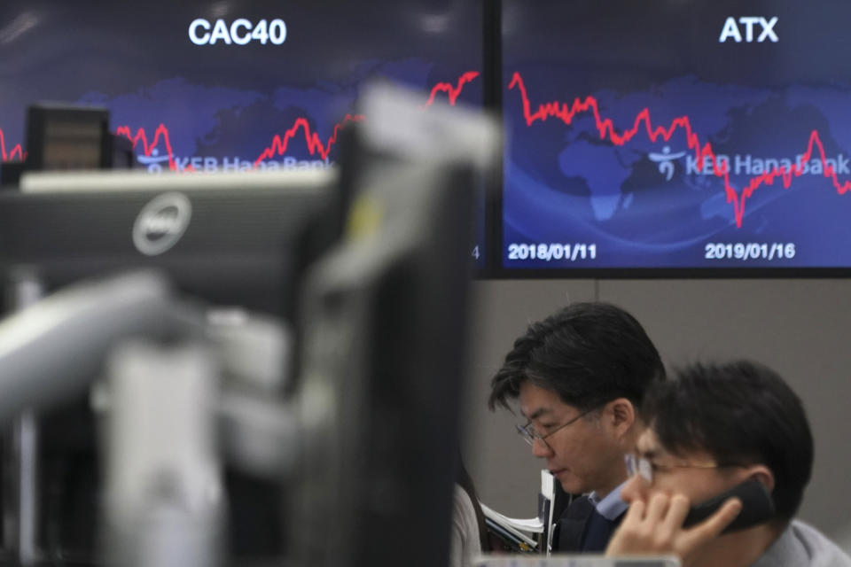 A currency trader talks on the phone at the foreign exchange dealing room in Seoul, South Korea, Wednesday, Jan. 15, 2020. Asian shares have retreated as conflicting reports raised concerns over the likely outcome of a trade deal to be signed by the U.S. and China. (AP Photo/Lee Jin-man)