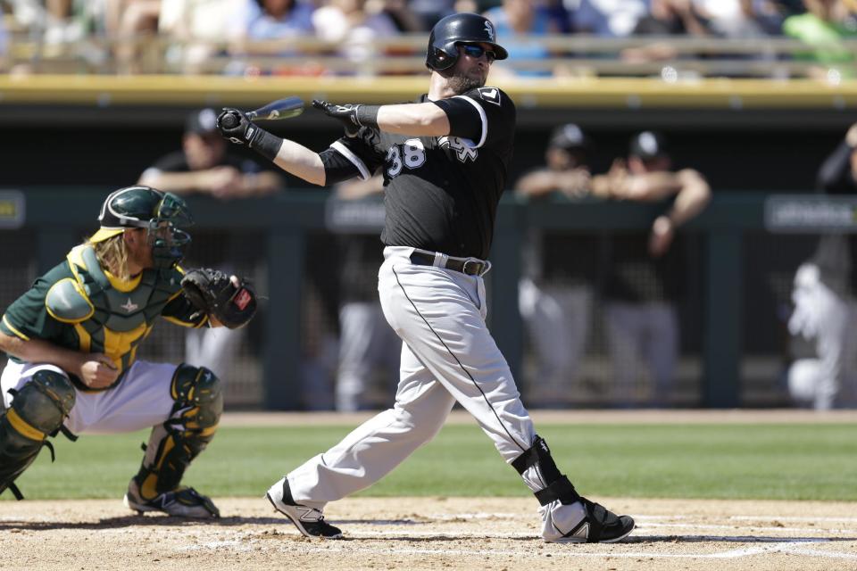 Chicago White Sox designated hitter Andy Wilkins swings against the Oakland Athletics during a spring training baseball game Sunday, March 8, 2015, in Mesa, Ariz. (AP Photo/Ben Margot)