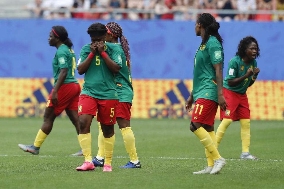 Cameron players react after a VAR decision that ruled out Cameroon's Ajara Nchout's goal for offside during the Women's World Cup round of 16 soccer match between England and Cameroon at the Stade du Hainaut stadium in Valenciennes, France, Sunday, June 23, 2019. (AP Photo/Michel Spingler)