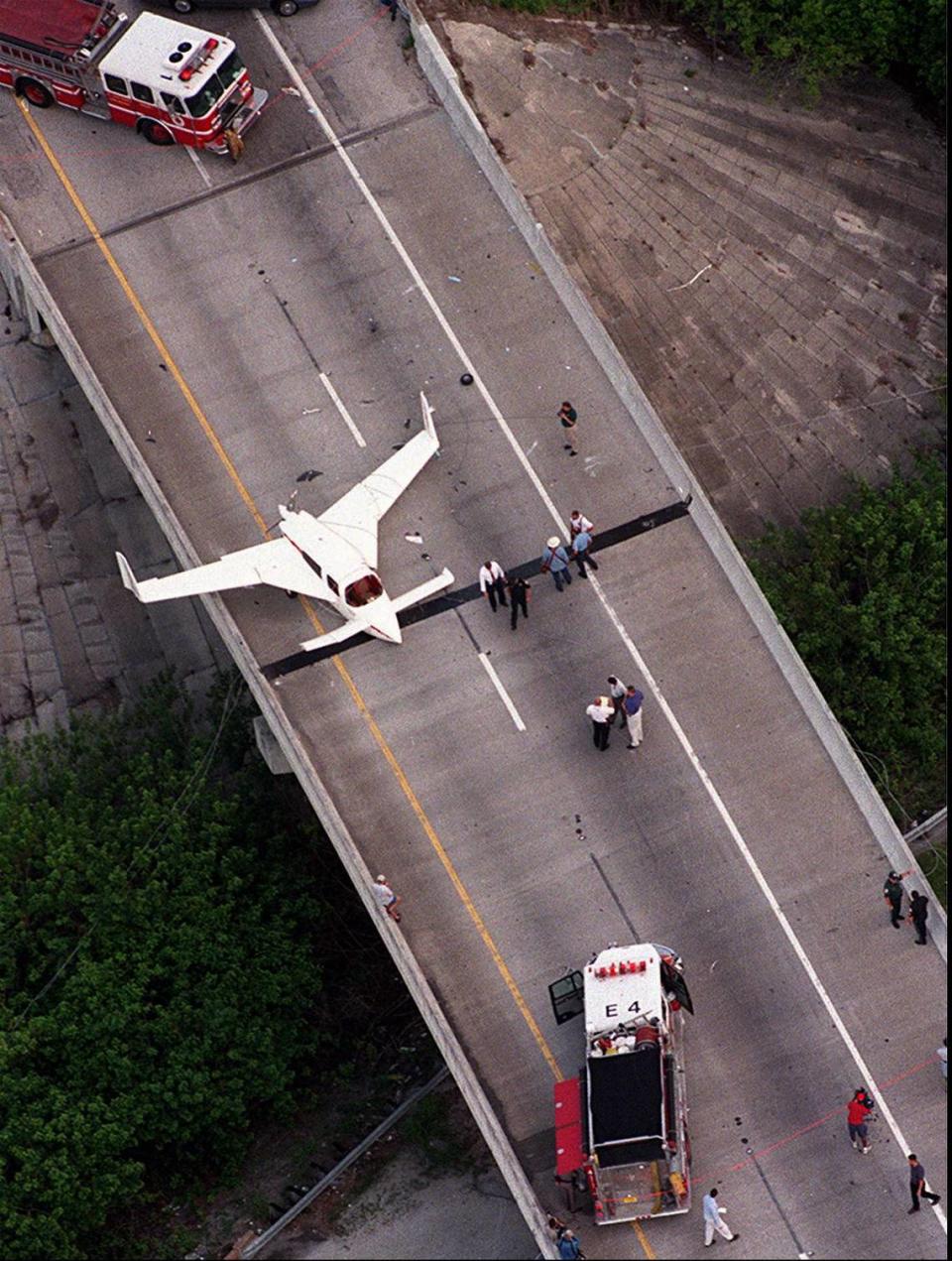 St. Lucie County Firefighters closed-off northbound Interstate 95 in Fort Pierce, Fla., after Donald White, of Pembroke Pines, Fla., landed his experimental plane on the Kings Highway overpass after experiencing engine problems Tuesday, June 15, 1999. No one was injured, but the highway was temporarily closed. (AP Photo/The Stuart News,Michael Beebe)