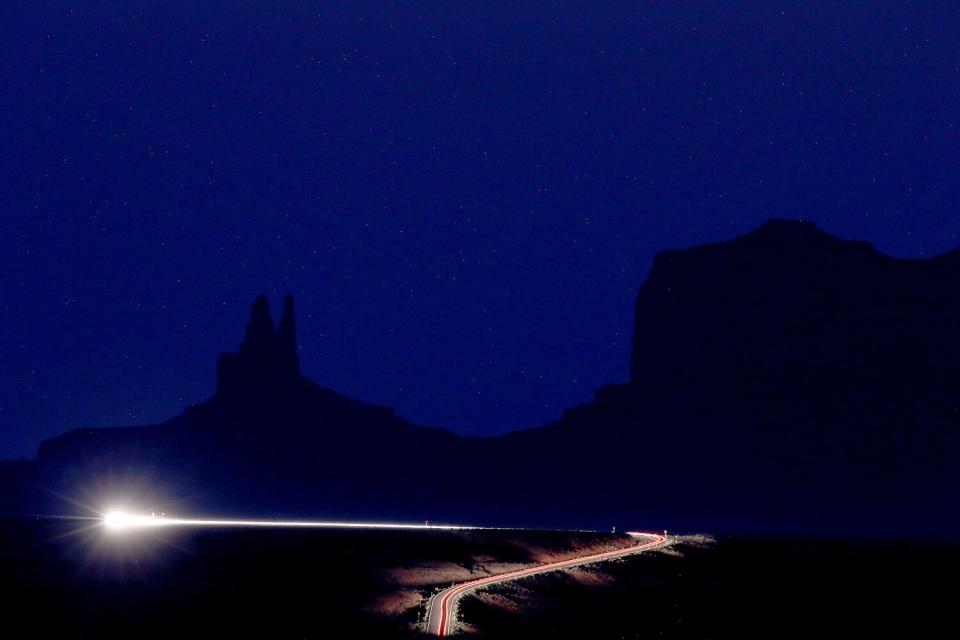 A motorist drives through Monument Valley, on the Utah-Arizona state line near the Four Corners area.