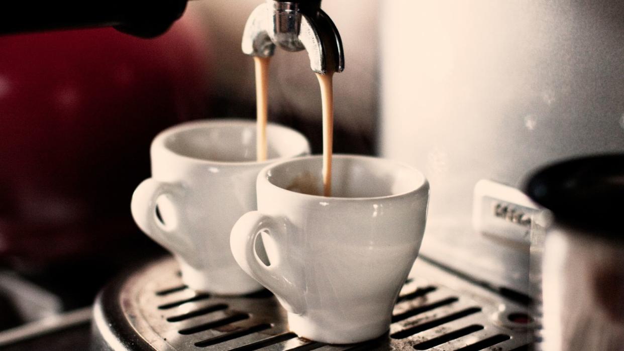  Do coffee makers save money? an espresso machine making two shots of coffee in ceramic espresso cups 