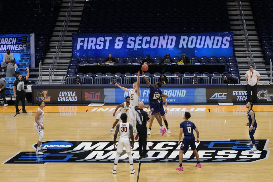 Georgia Tech tips off with Loyola Chicago at the start of a college basketball game in the first round of the NCAA tournament at Hinkle Fieldhouse, Indianapolis, Friday, March 19, 2021. (AP Photo/AJ Mast)