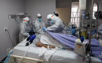 FILE - In this July 6, 2020, file photo, blanket is pulled to cover the body of a patient after medical personnel were unable to to save her life inside the coronavirus unit at United Memorial Medical Center in Houston. The U.S. death toll from COVID-19 has topped 500,000 — a number so staggering that a top health researchers says it is hard to imagine an American who hasn't lost a relative or doesn't know someone who died. (AP Photo/David J. Phillip, File)