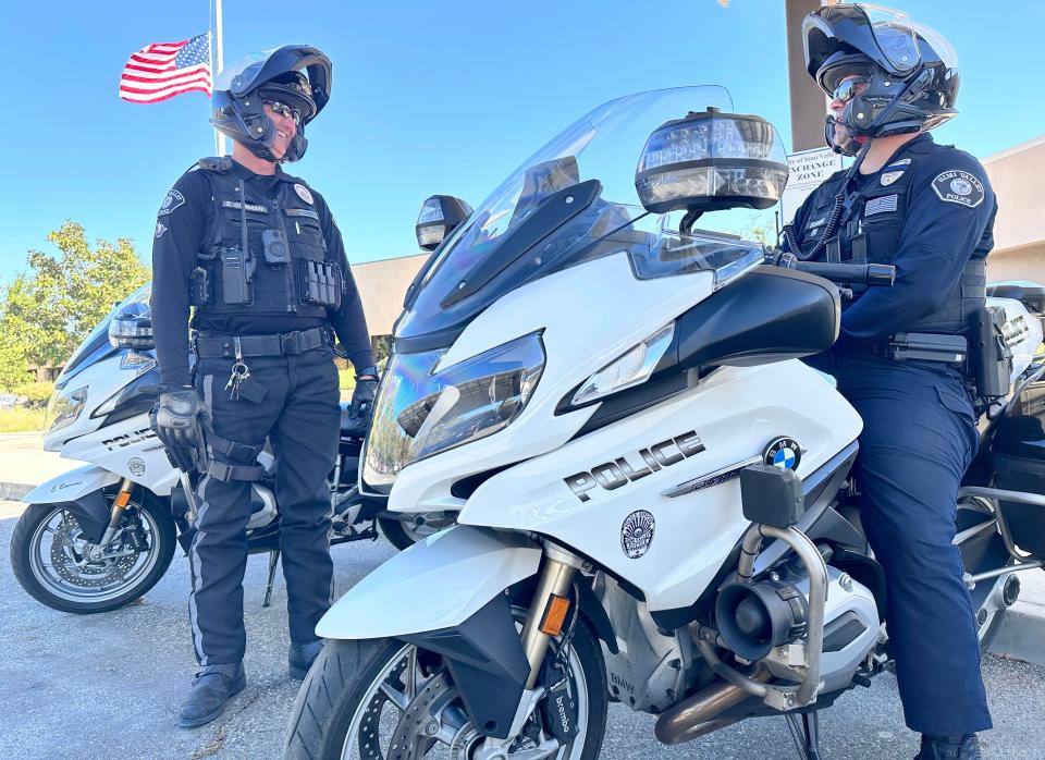 Simi Valley Police motorcycle officer Eric Bowman, left, and officer Brett Suliga, a motorcycle trainee, get ready to ride from the station on Thursday.