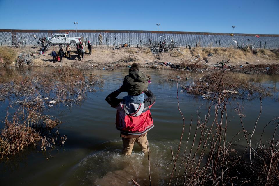 A father carries his daughter across the Rio Bravo from Ciudad Juárez to El Paso hoping to seek asylum on Jan. 6, 2024. El Paso Sector has seen a reduction of migrant crossings in the first weeks of the year after hundreds were crossing daily in December.