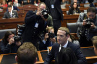Facebook Chief Executive Officer Mark Zuckerberg, center, is surrounded by photographers after arriving for a hearing before the House Financial Services Committee on Capitol Hill in Washington, Wednesday, Oct. 23, 2019, to discuss his plans for the new cryptocurrency Libra. (AP Photo/Susan Walsh)
