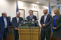 Oklahoma Attorney General Mike Hunter, center, answers a question during a news conference following the announcement of the Opioid Lawsuit decision in Norman, Okla., Monday, Aug. 26, 2019. Pictured from left are attorneys Reggie Whitten, Michael Burrage, Hunter, attorney Brad Beckworth and Terri White, Commissioner, Oklahoma Department of Mental Health and Substance Abuse Services. (AP Photo/Sue Ogrocki)