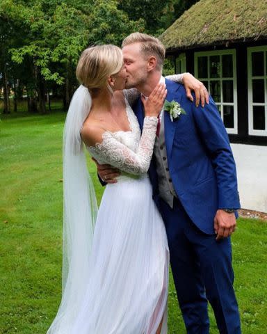 <p>Kevin Magnussen Instagram</p> Kevin Magnussen and Louise Gjorup share a kiss on their wedding day.