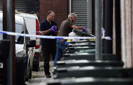 Investigators search rubbish bins behind a police cordon after three men were arrested in connection with an explosion on the London Underground, in Newport, Wales, Britain, September 20, 2017. REUTERS/Rebecca Naden