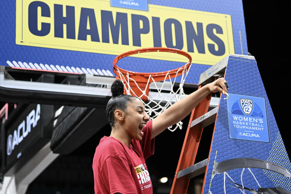 LAS VEGAS, NEVADA - MARCH 10: JuJu Watkins #12 of the USC Trojans celebrates cutting a piece of a net down after the team's victory over the Stanford Cardinal 74-61 in the championship game of the Pac-12 Conference women's basketball tournament at MGM Grand Garden Arena on March 10, 2024 in Las Vegas, Nevada. (Photo by Candice Ward/Getty Images)