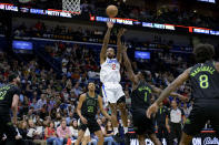 Los Angeles Clippers forward Kawhi Leonard (2) shoots against New Orleans Pelicans forward Zion Williamson (1) during the first half of an NBA basketball game in New Orleans, Friday, March 15, 2024. (AP Photo/Matthew Hinton)
