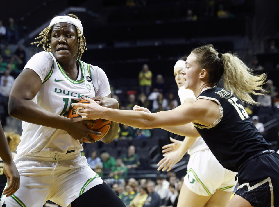 Oregon center Phillipina Kyei, left, fights for possession against Colorado guard Kindyll Wetta, right, during an NCAA college basketball game in Eugene, Ore., Sunday, Jan. 28, 2024. (AP Photo/Thomas Boyd)