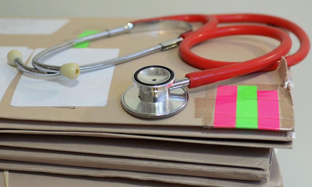 Stethoscope sitting on a pile of files