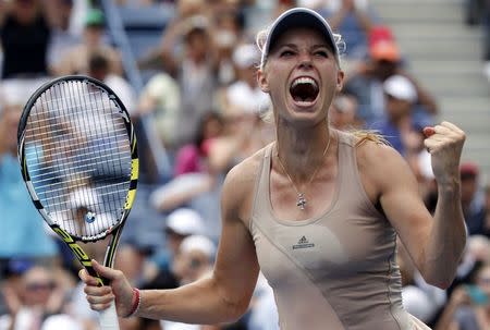 Caroline Wozniacki of Denmark celebrates her win over Maria Sharpova of Russia at the 2014 U.S. Open tennis tournament in New York, August 31, 2014. REUTERS/Ray Stubblebine