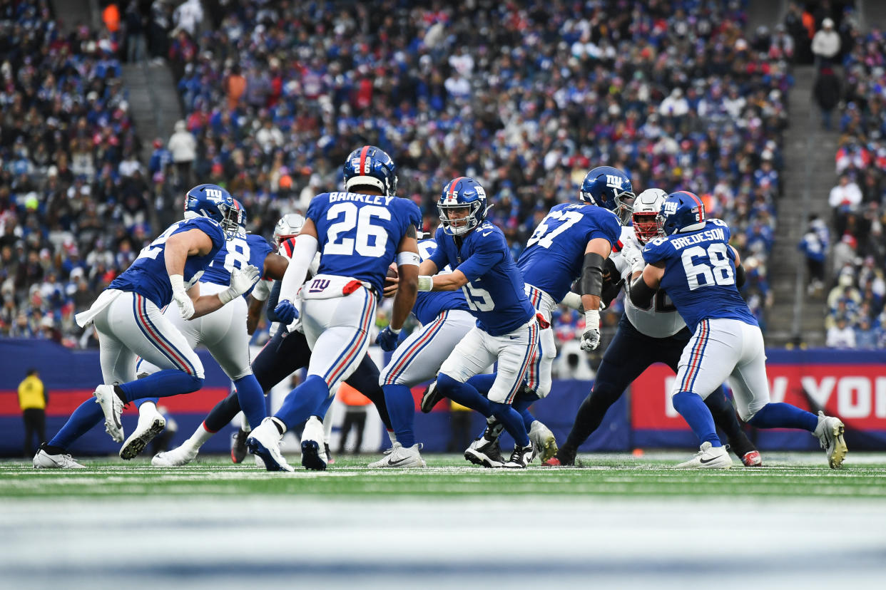 Tommy DeVito #15 of the New York Giants hands the ball off to Saquon Barkley (26). (Photo by Kathryn Riley/Getty Images)
