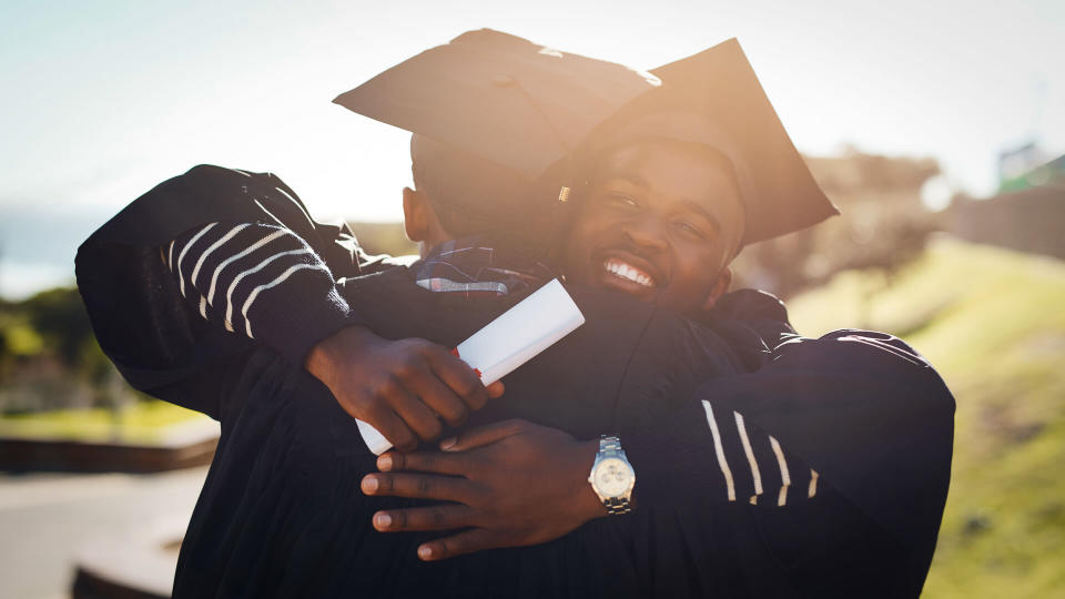 college graduate hugging his college friend