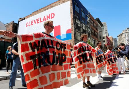 Protesters hold a banner reading "Wall Off Trump" outside an entrance to the arena hosting the Republican National Convention in Cleveland, Ohio, U.S. July 19, 2016. REUTERS/Lucas Jackson