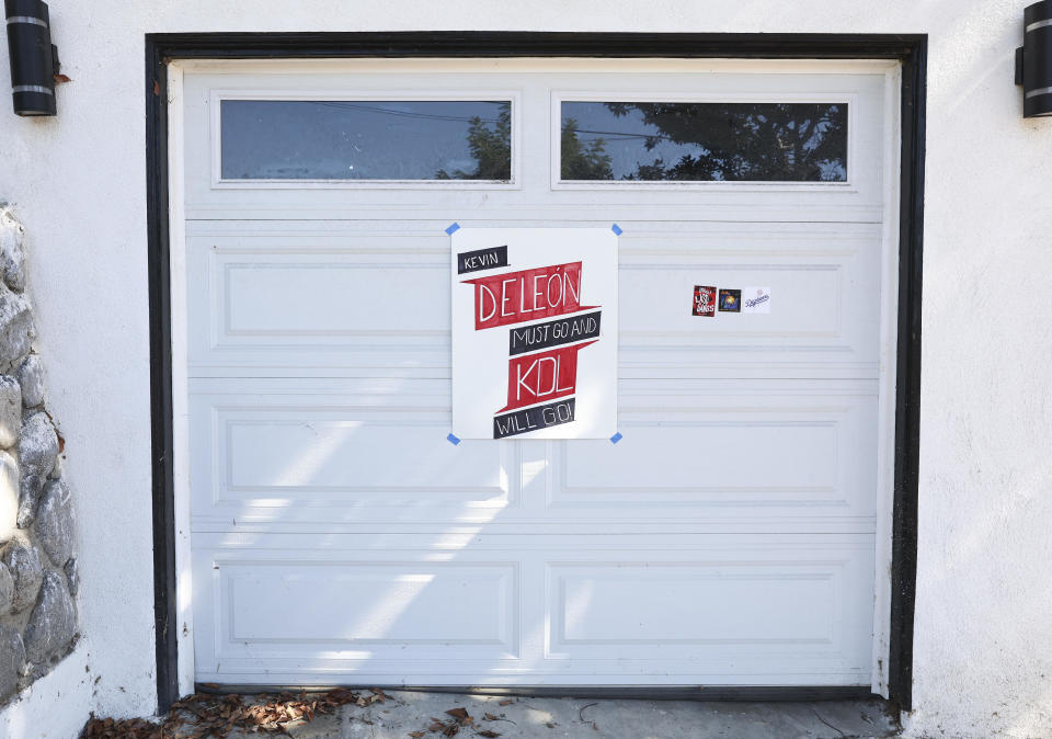 A sign calling for the resignation of L.A. City Council member Kevin de Leon is posted on the garage of de Leon's home in the wake of a leaked audio recording on October 18, 2022 in Los Angeles, California.  / Credit: Mario Tama / Getty Images