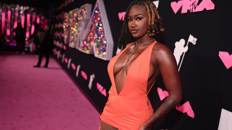 Rapper Kaliii offered a pop of color in a bright orange cut-out gown.  - Christopher Polk/Variety/Getty Images