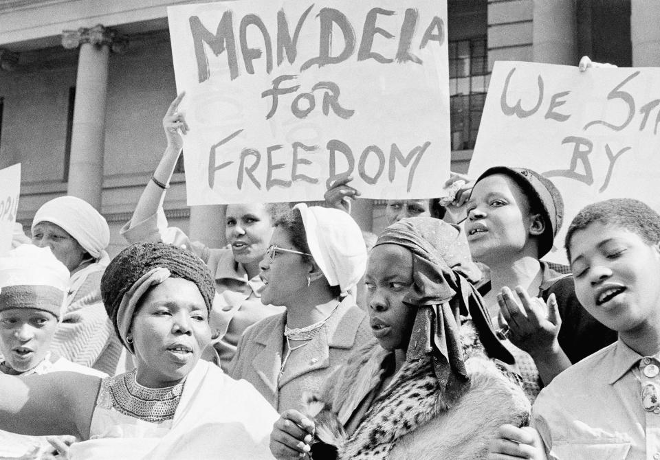 <p>African women join in a demonstration in South Africa, Aug. 16, 1962, demanding the release of Nelson Mandela, former secretary of the banned African National Congress, who appeared in court on a charge of incitement. The women, together with Winnie Mandela, chanted “Down with Verwoerd” on the steps of the Johannesburg City Hall. (Photo: Dennis Lee Royle/AP) </p>