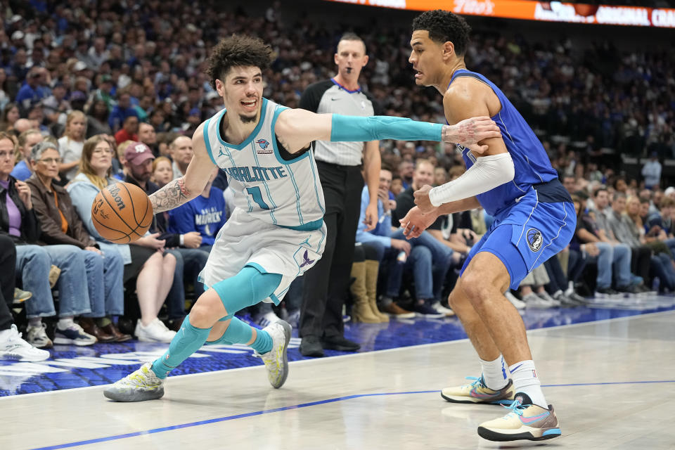 DALLAS, TEXAS - NOVEMBER 05: LaMelo Ball #1 of the Charlotte Hornets drives past Josh Green #8 of the Dallas Mavericks during the second half at American Airlines Center on November 05, 2023 in Dallas, Texas. NOTE TO USER: User expressly acknowledges and agrees that, by downloading and or using this photograph, User is consenting to the terms and conditions of the Getty Images License Agreement. (Photo by Sam Hodde/Getty Images)
