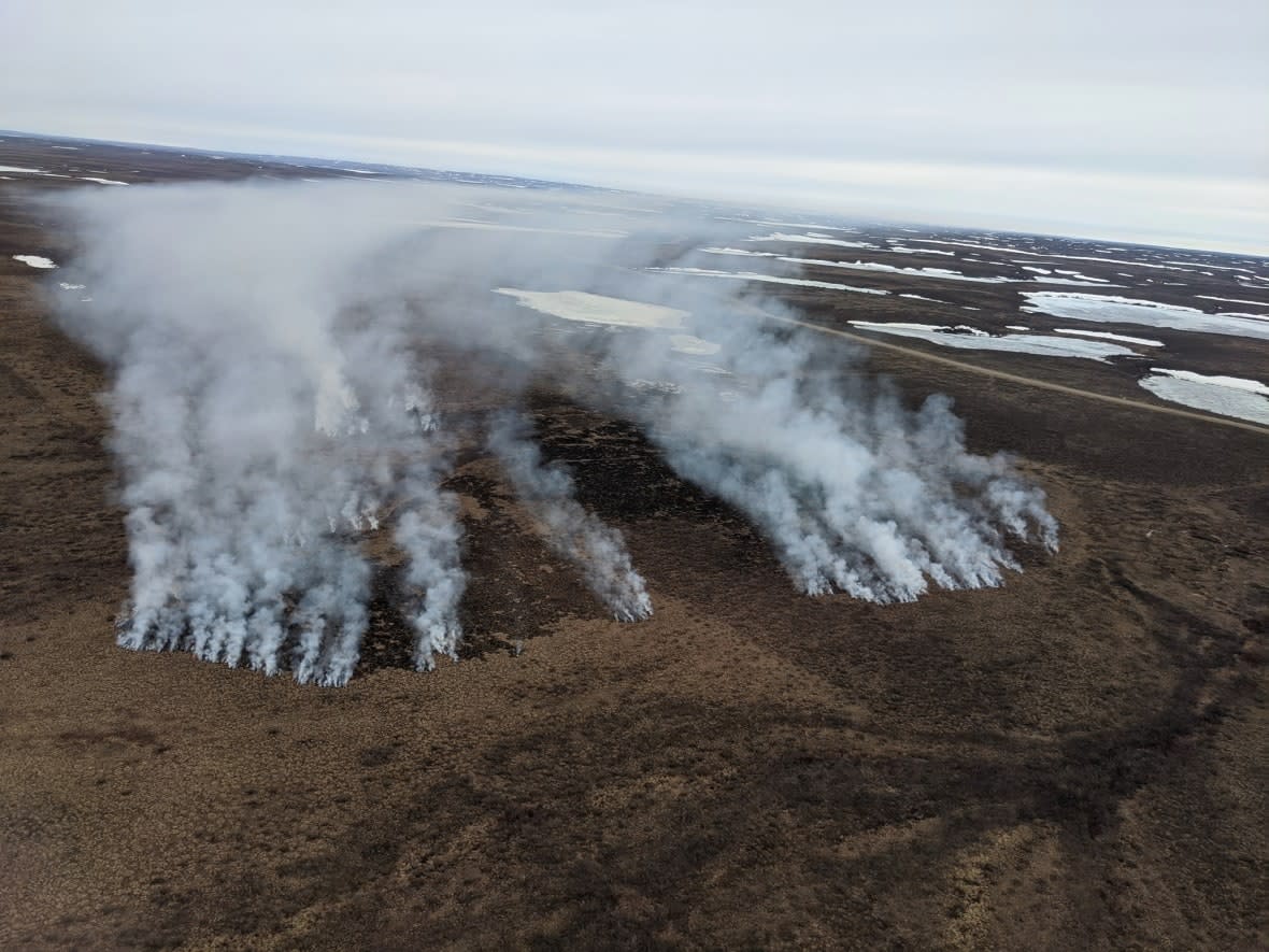 A file photo taken June 8 shows a forest fire along the Inuvik Tuktoyaktuk Highway. There were 97 fires burning in the N.W.T. on Monday morning. (N.W.T. Environment and Natural Resources - image credit)
