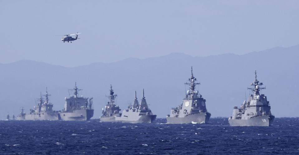 Japan's Maritime Self-Defense Force destroyer Asahi, right, and other warships join an international fleet review in Sagami Bay, south of Tokyo, Sunday, Nov. 6, 2022. Eighteen warships participated from 12 countries, including the United States, Australia, Canada, India, New Zealand, Singapore and South Korea, while the United States and France also sent warplanes for the review. (Iori Sagisawa/Kyodo News via AP)