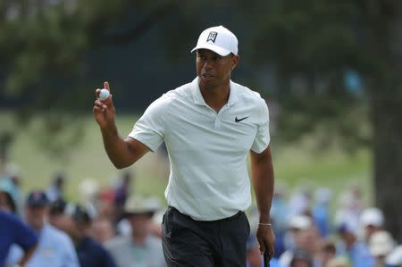 Tiger Woods of the U.S. holds up his ball after putting on the 7th hole to make par during second round play of the 2018 Masters golf tournament at the Augusta National Golf Club in Augusta, Georgia, U.S., April 6, 2018. REUTERS/Brian Snyder