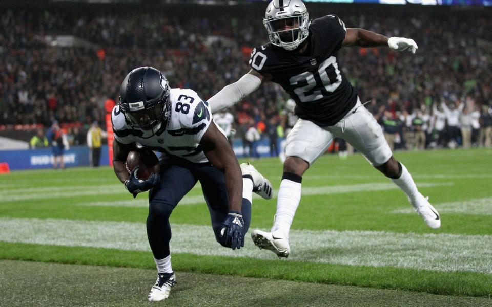 This photographer is about to get a very good close up of David Moore, who scored a TD before crashing into the assembled snappers - Getty Images Europe