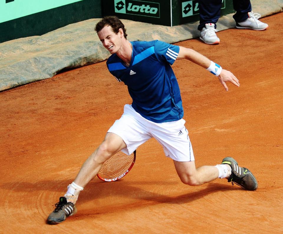 Britain's Andy Murray grimaces during a Davis Cup World Group quarterfinal tennis match against Italy's Fabio Fognini in Naples, Italy, Sunday, April 6, 2014. (AP Photo/Salvatore Laporta)