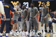 West Virginia players meet on court during the first half of an NCAA college basketball game against Auburn on Saturday, Jan. 28, 2023, in Morgantown, W.Va. (AP Photo/Kathleen Batten)