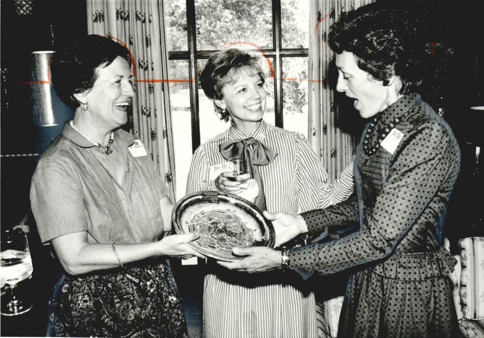 In a Sept. 9, 1982, file photo, artist Janie Crain, left, presents a plate to arts patron Joan Mondale, the wife of former U.S. Vice President Walter Mondale, as Betty Price looks on.