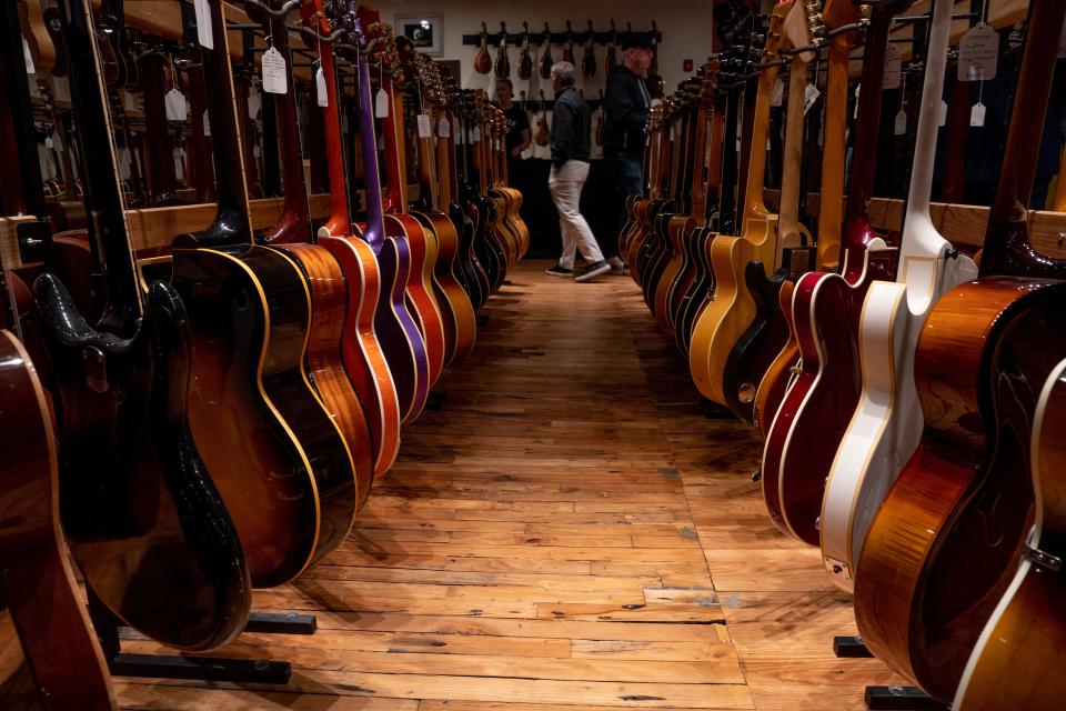 New and used guitars line an aisle at Carter Vintage Guitars on Eighth Avenue in Nashville.