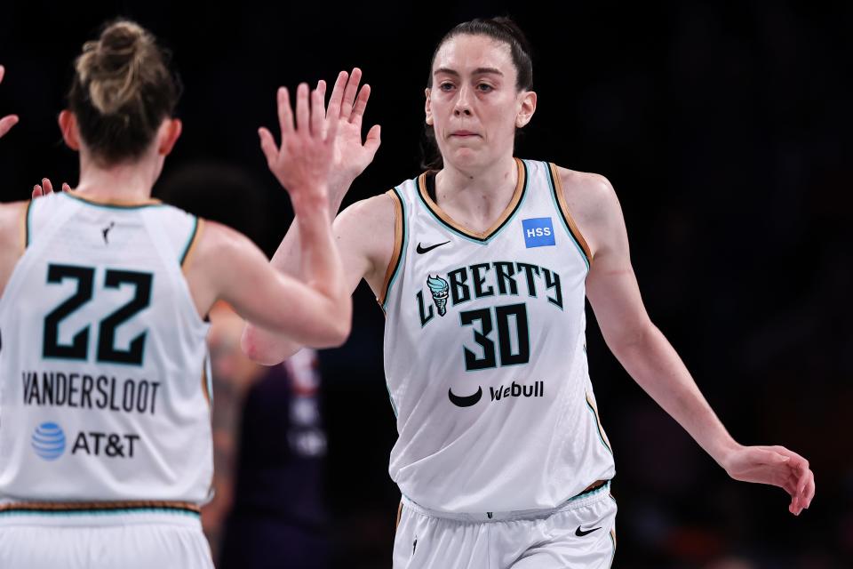 New York Liberty forward Breanna Stewart (30) high-fives teammate Courtney Vandersloot during a game against the Phoenix Mercury on July 5.