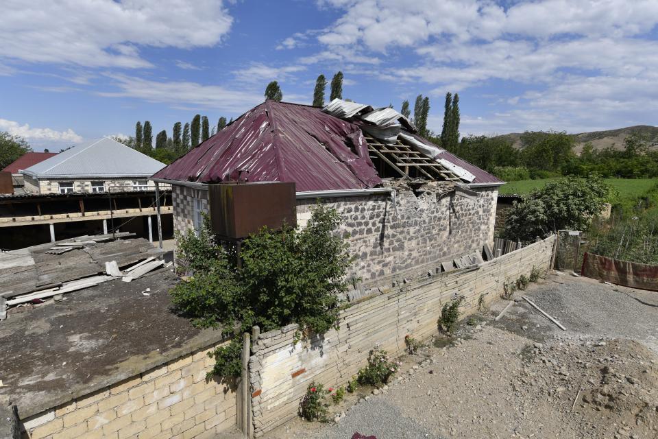 A damaged house is seen after shelling by Armenian forces in the Tovuz region of Azerbaijan, Tuesday, July 14, 2020. Skirmishes on the volatile Armenia-Azerbaijan border escalated Tuesday, marking the most serious outbreak of hostilities between the neighbors since the fighting in 2016. (AP Photo/Ramil Zeynalov)