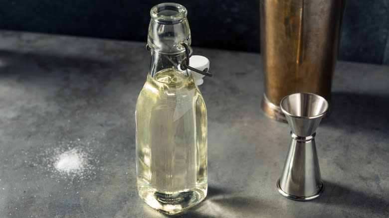 Bottle of simple syrup with jigger