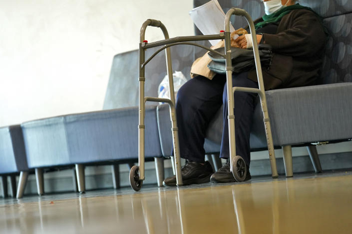 A patient waits to be seen at the Mountain Park Health Center, Thursday, March 30, 2023, in Phoenix. As heat waves fueled by climate change arrive earlier, grow more intense and last longer, people over 60 who are more vulnerable to high temperatures are increasingly at risk of dying from heat-related causes. Heat related deaths are challenging community health systems, utility companies, apartment managers and local governments to better protect older people when temperatures soar.(AP Photo/Matt York)