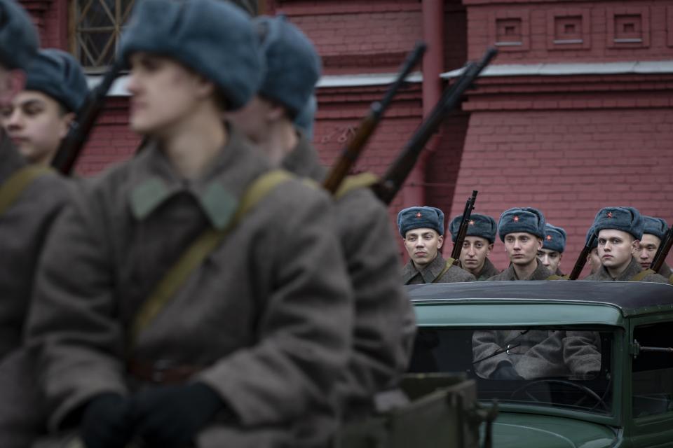 Russian soldiers dressed in Red Army World War II winter uniforms sit in trucks as they wait to take a part in a reconstruction of a World War II-era parade in Moscow's Red Square, Russia, Thursday, Nov. 7, 2019. The Nov. 7, 1941 parade saw Red Army soldiers move directly to the front line in the Battle of Moscow, becoming a symbol of Soviet valor and tenacity in the face of overwhelming odds. (AP Photo/Alexander Zemlianichenko)