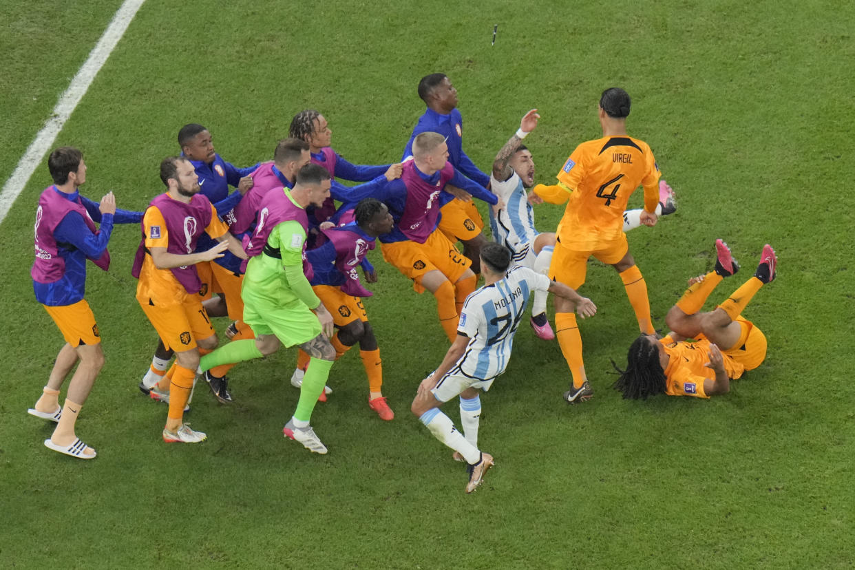 Players scuffle during the World Cup quarterfinal soccer match between the Netherlands and Argentina, at the Lusail Stadium in Lusail, Qatar, Friday, Dec. 9, 2022. (AP Photo/Hassan Ammar)