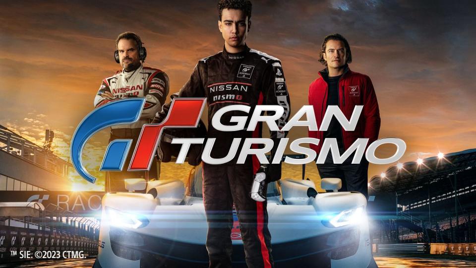 gran turismo movie a group of men standing next to a car with a large logo